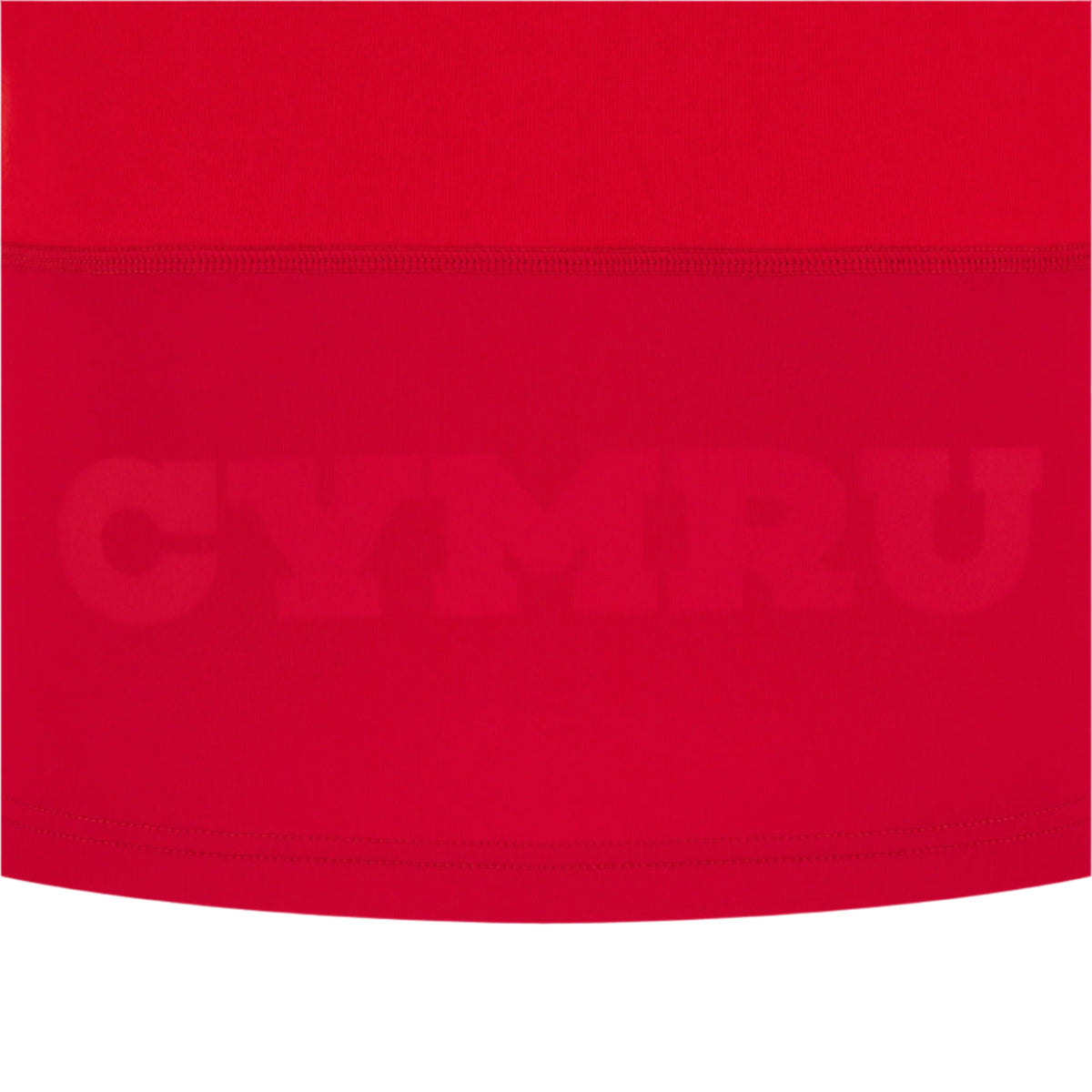 The Wales 25/26 Replica Home Cotton Jersey by Macron features red fabric with "CYMRU" subtly embossed in large capitals across the lower section, inspired by classic Wales rugby jerseys.