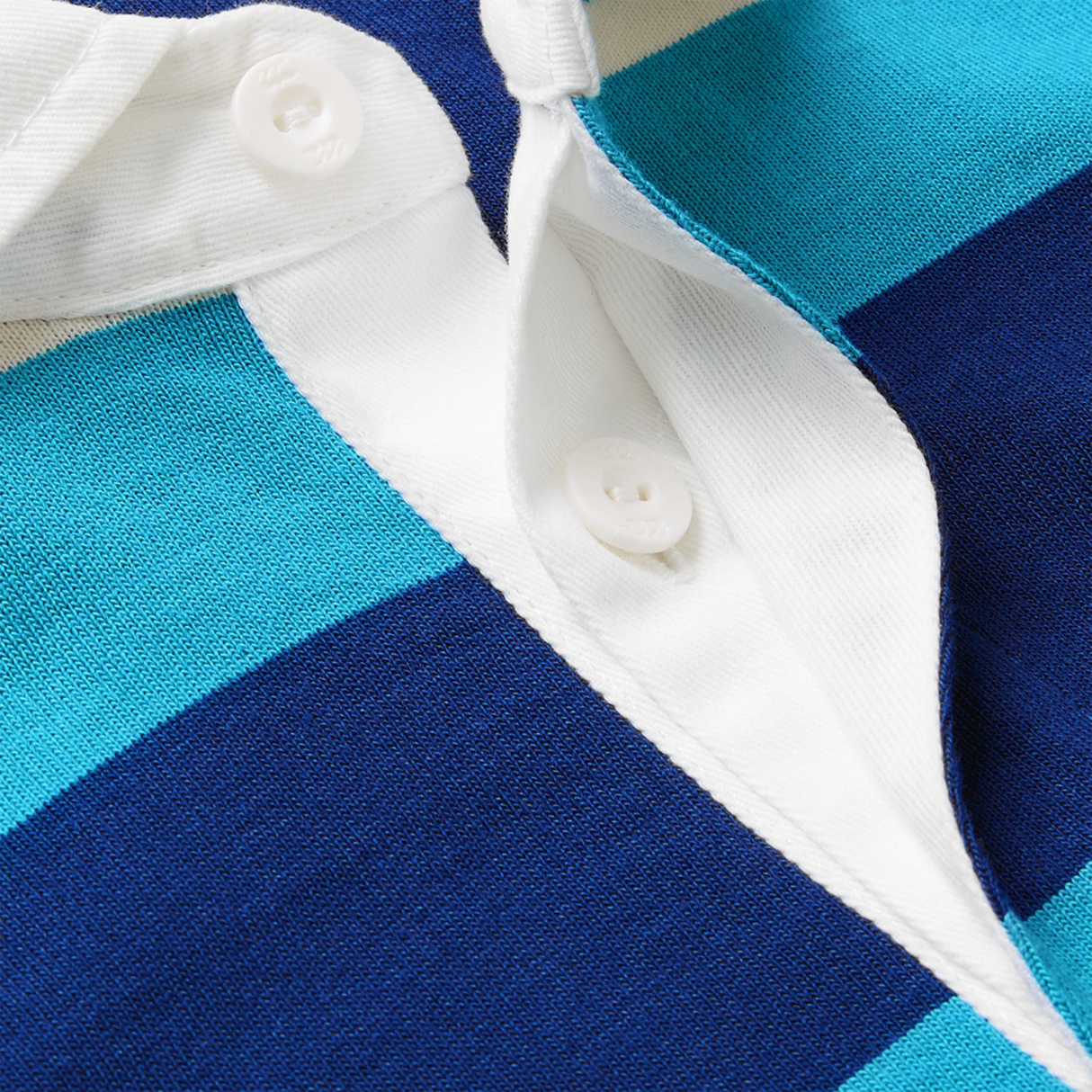 Close-up of the Canterbury Stripe Classic Rugby Jersey by Canterbury in blue and turquoise, with a white collar, two white buttons (one left unbuttoned), and crafted from a durable cotton blend.