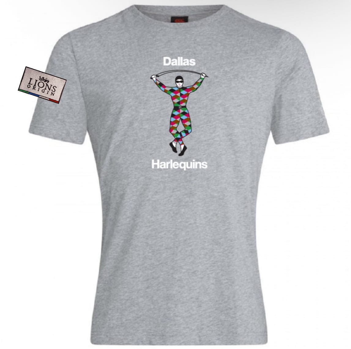 The Dallas Harlequins Lions Origin Club Plain Tee by WRS Canterbury features a harlequin jumping rope, "Dallas" above and "Harlequins" below the graphic, in a gray cotton-rich blend with a small "Lions" tag on the left.