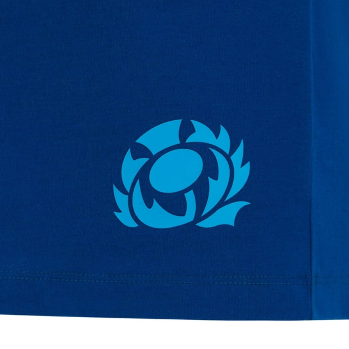 The Scotland 25/26 Murrayfield Stadium T-Shirt by Macron features a stylized light blue thistle logo near the bottom hem, inspired by Murrayfield Stadium.