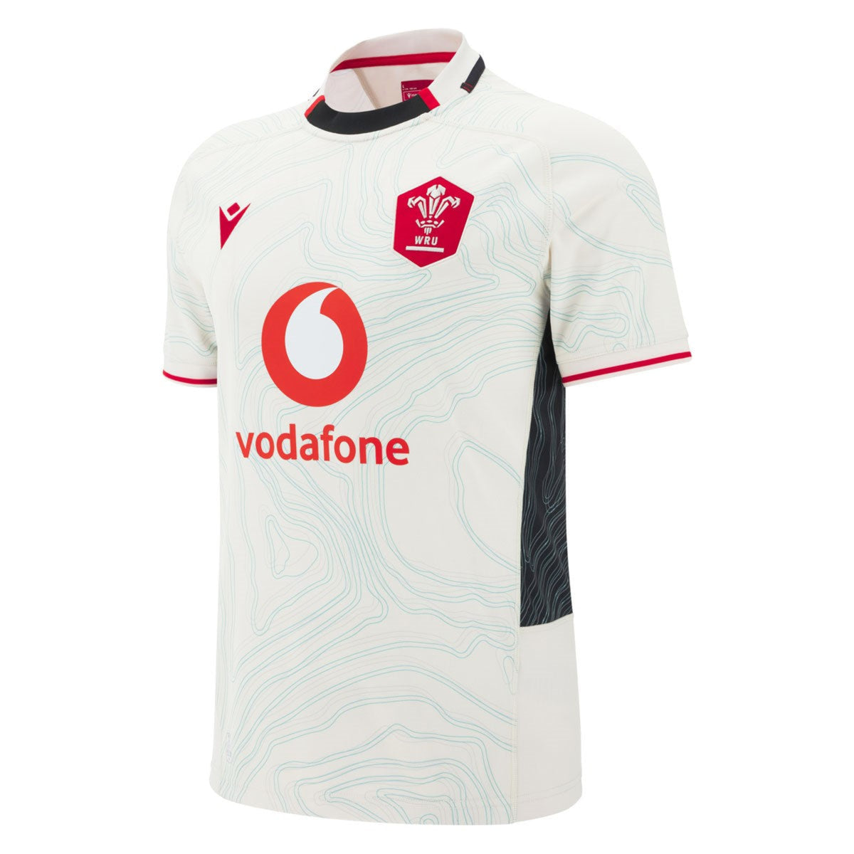 The Wales 25/26 Replica Away Jersey by Macron features light blue contour lines, red edges, WRU logo, Macron branding, and Vodafone sponsor logo on the front.