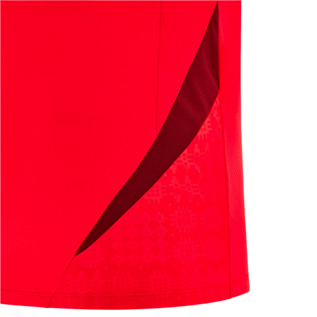 Close-up of the Wales 25/26 Player Training Shirt by Macron, a red athletic shirt with a dark red mesh panel and subtle geometric patterns on the fabric.