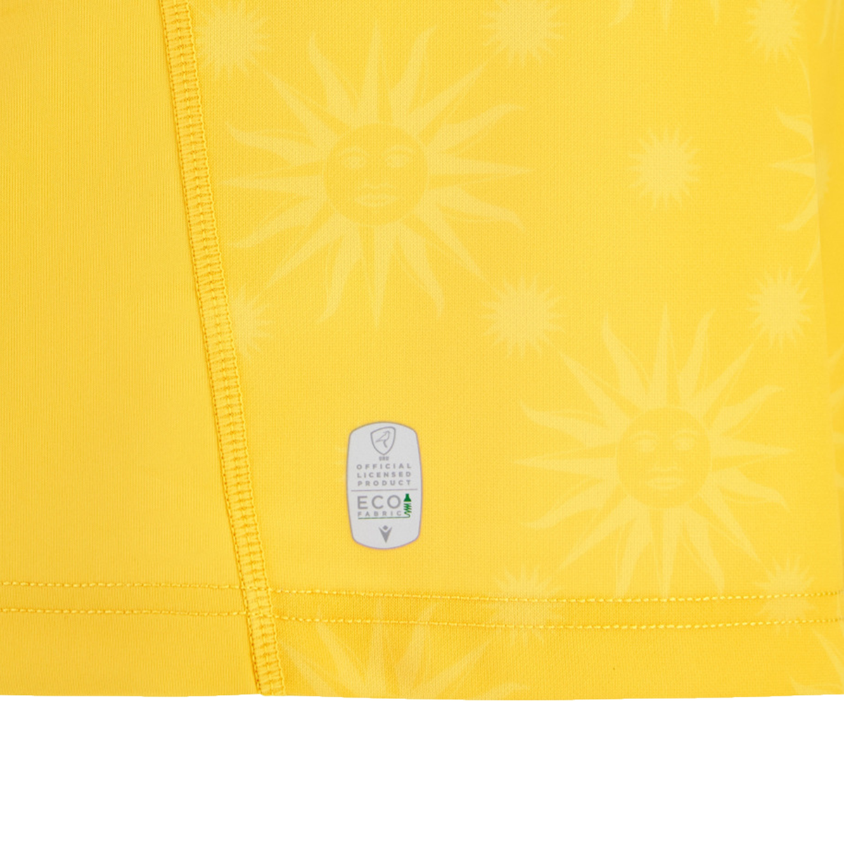 Close-up of yellow fabric with sun face patterns and visible stitching, featuring an EcoFightex label—recalling the fine details on the Uruguay URU 25/26 Replica Away Jersey by Macron.