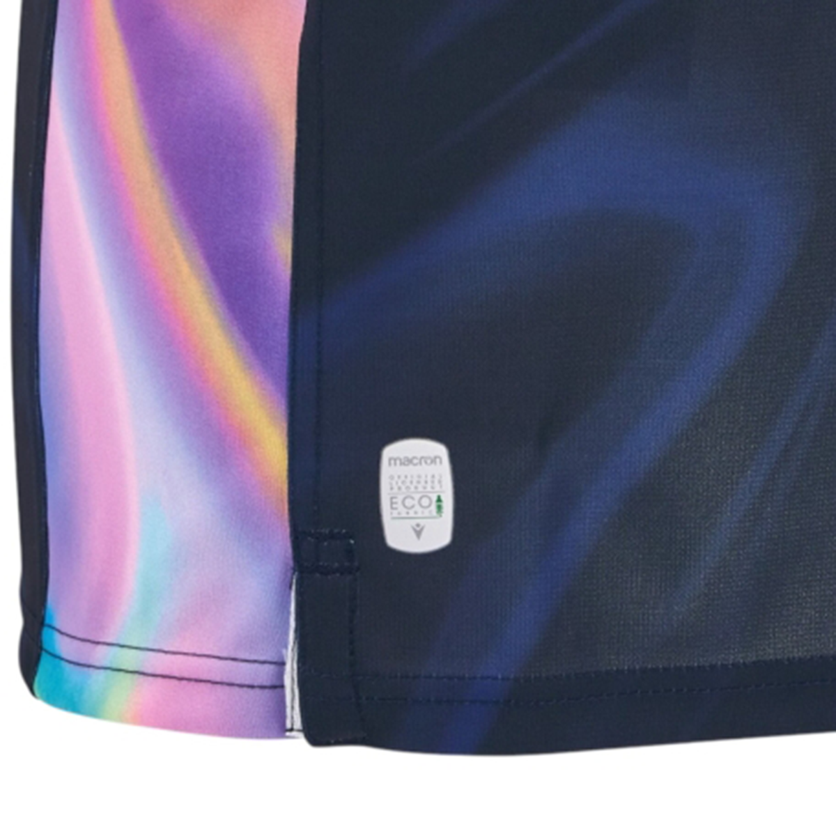 Close-up of the Uruguay URU 25/26 Replica Training Jersey by Macron, showing dark blue fabric with a multicolored pastel side pattern and a small "Macron Eco" label near the hem.