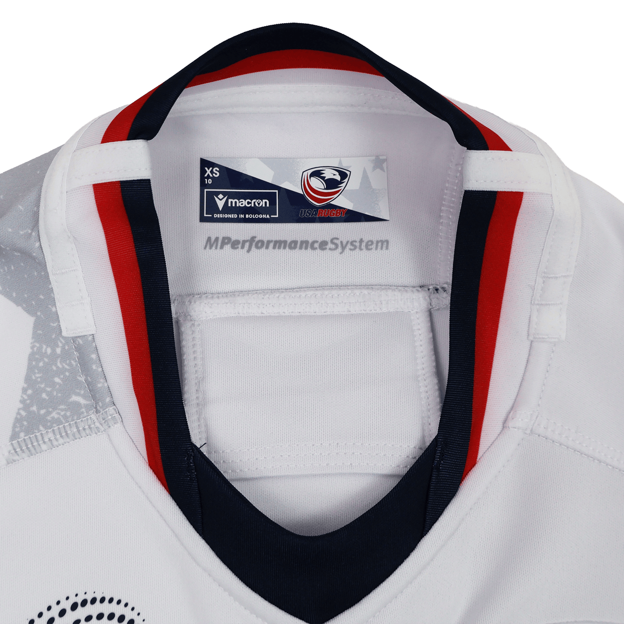 Close-up of the inside collar on the Women's USA Rugby WRWC 25 Away Bodyfit Shirt by Macron, featuring the Macron brand tag, USA Rugby logo, and "MPerformanceSystem" text for comfort and performance.