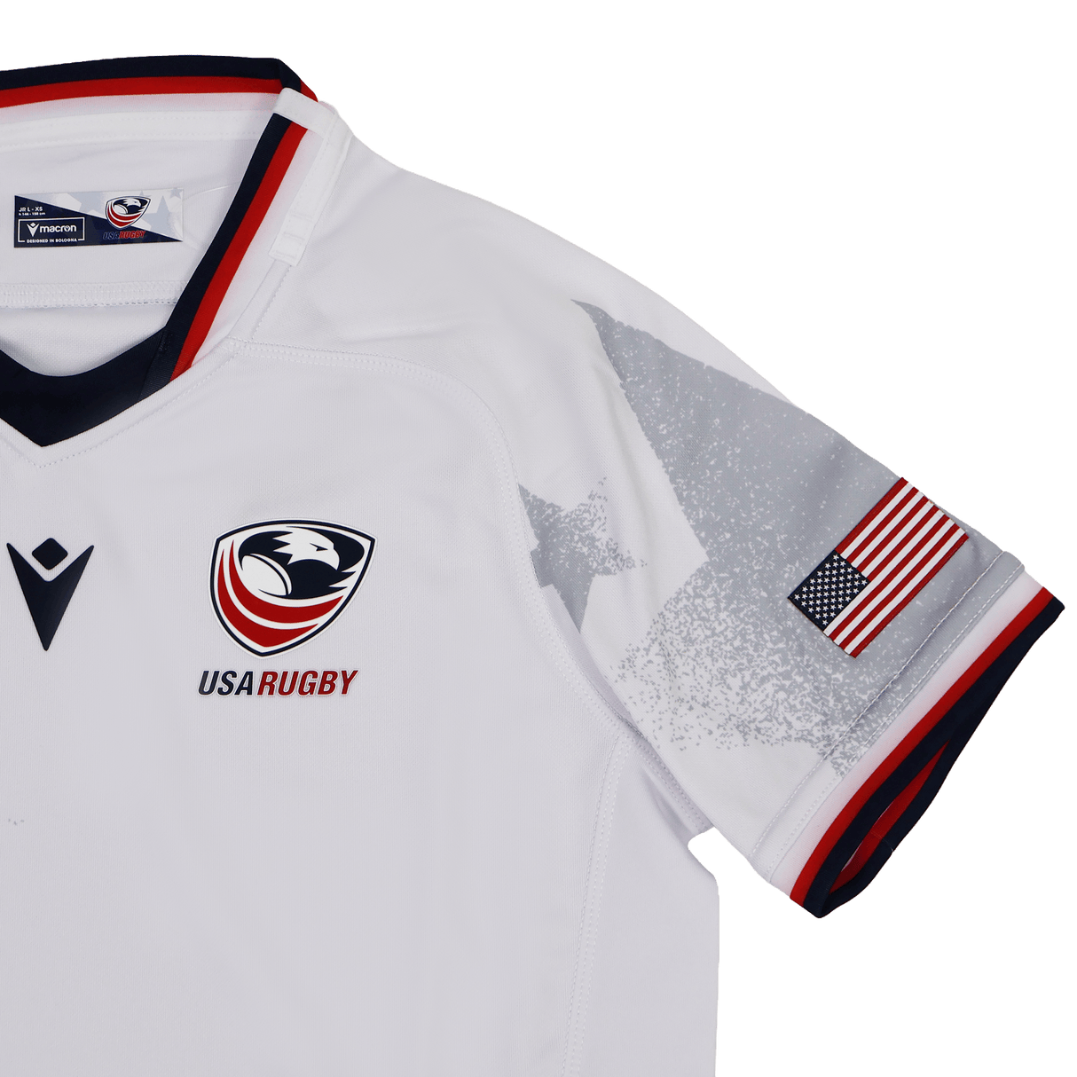 The Youth USA Rugby WRWC 25 Home Jersey by Macron features the team logo, WRWC 25 detail, an American flag sleeve patch, and grey star graphics on the shoulders.