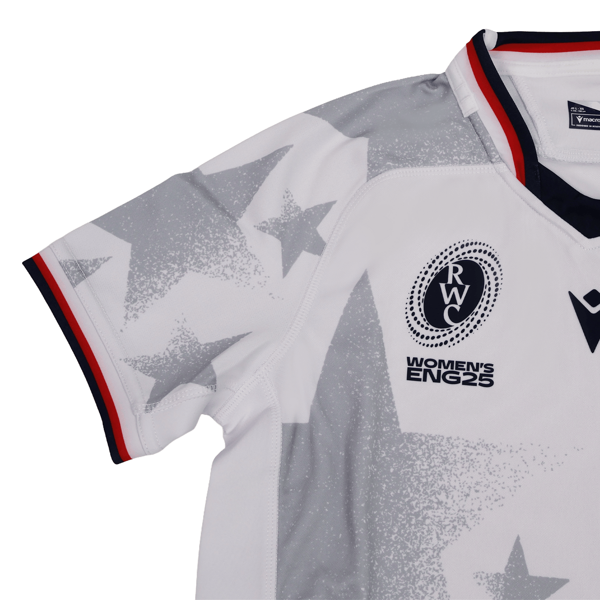 The Youth USA Rugby WRWC 25 Home Jersey by Macron features white fabric, gray star patterns, a red, white, and blue collar, and chest emblems reading “RWC,” “Women’s ENG25,” and “WRWC 25.”.