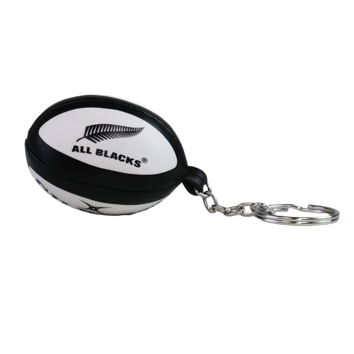 The All Blacks Ball Keyring by Gilbert, shaped like a rugby ball and featuring the iconic All Blacks logo and a silver ring, is displayed on a white surface.