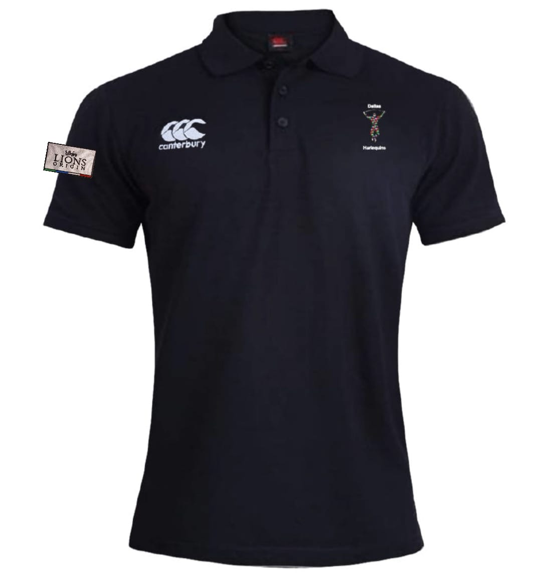 The Dallas Harlequins Lions Origin Waimak Polo by EMB Canterbury is a black short-sleeved rugby polo with a collar, white Canterbury logo, embroidered crest, "Lions" patch on the left sleeve, and is made from a cotton-polyester blend.