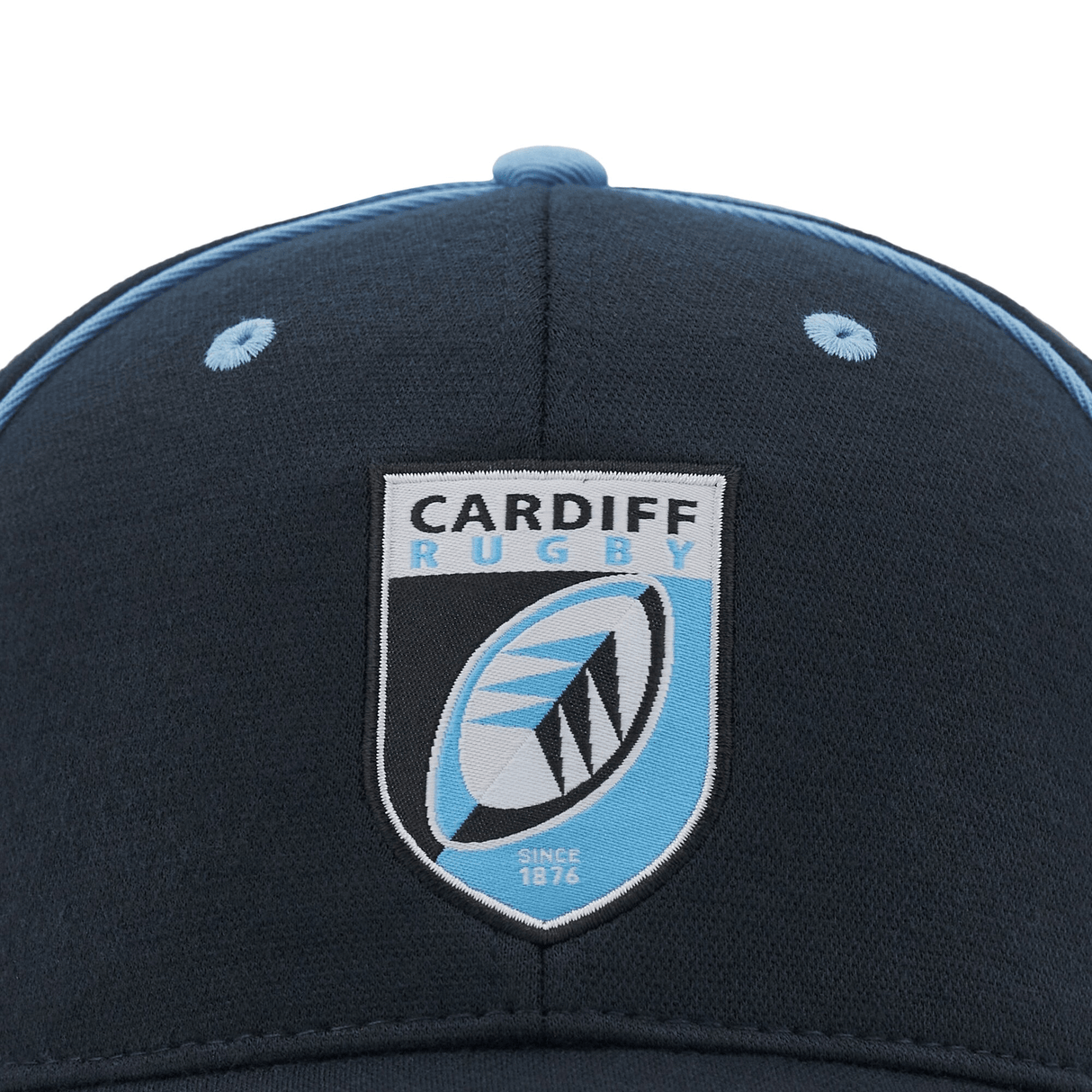 Close-up of the Cardiff Rugby logo on a dark blue Cardiff 24/25 Baseball Cap by Macron, featuring light blue accents and an adjustable buckle for a perfect fit.