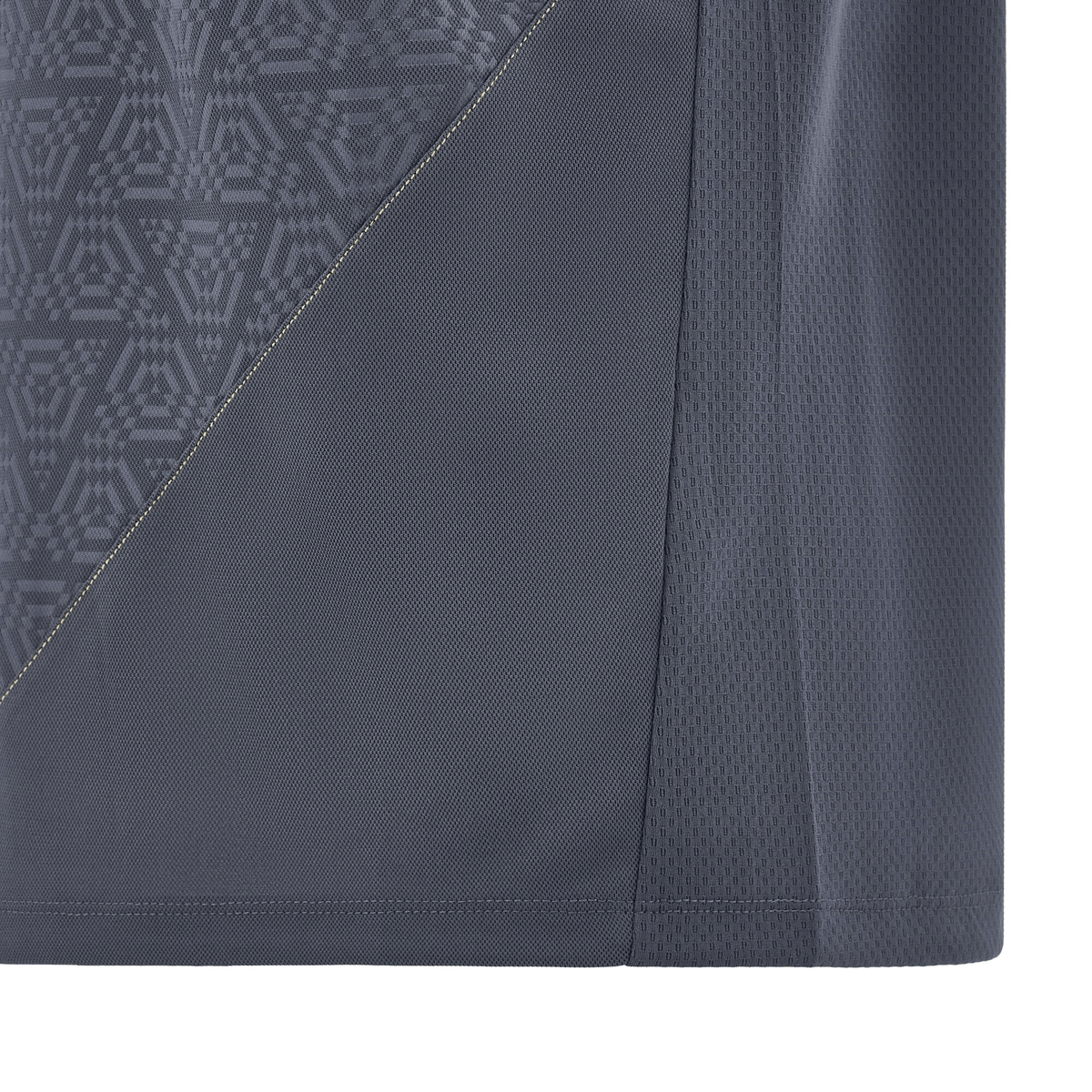 Close-up of the Wales 24/25 Travel Polo by Macron, showcasing a gray fabric pattern with geometric designs reminiscent of Welsh artistry, divided by a contrasting diagonal seam.