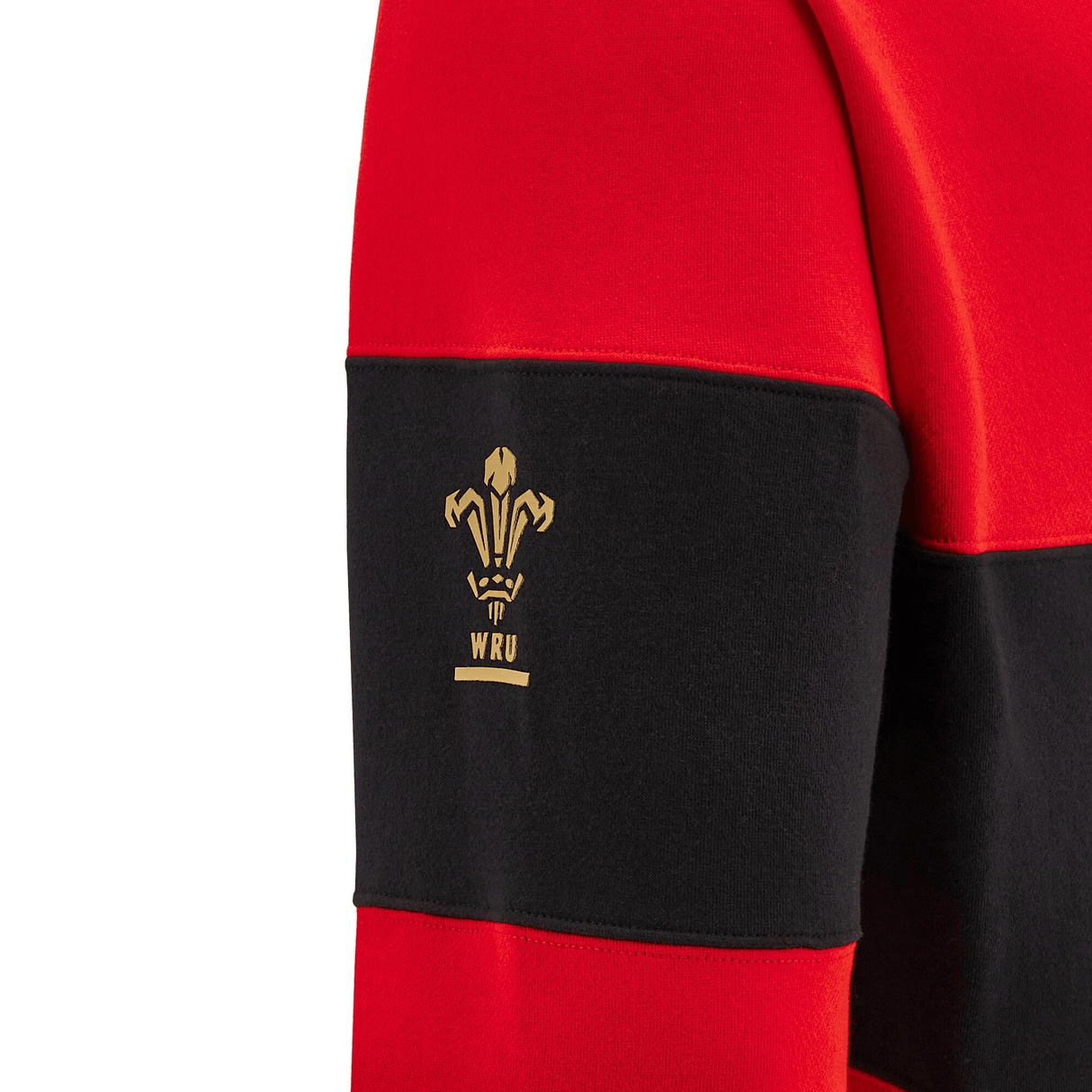 Close-up of a red and black hoodie sleeve featuring the WRU logo in gold, crafted by Macron.