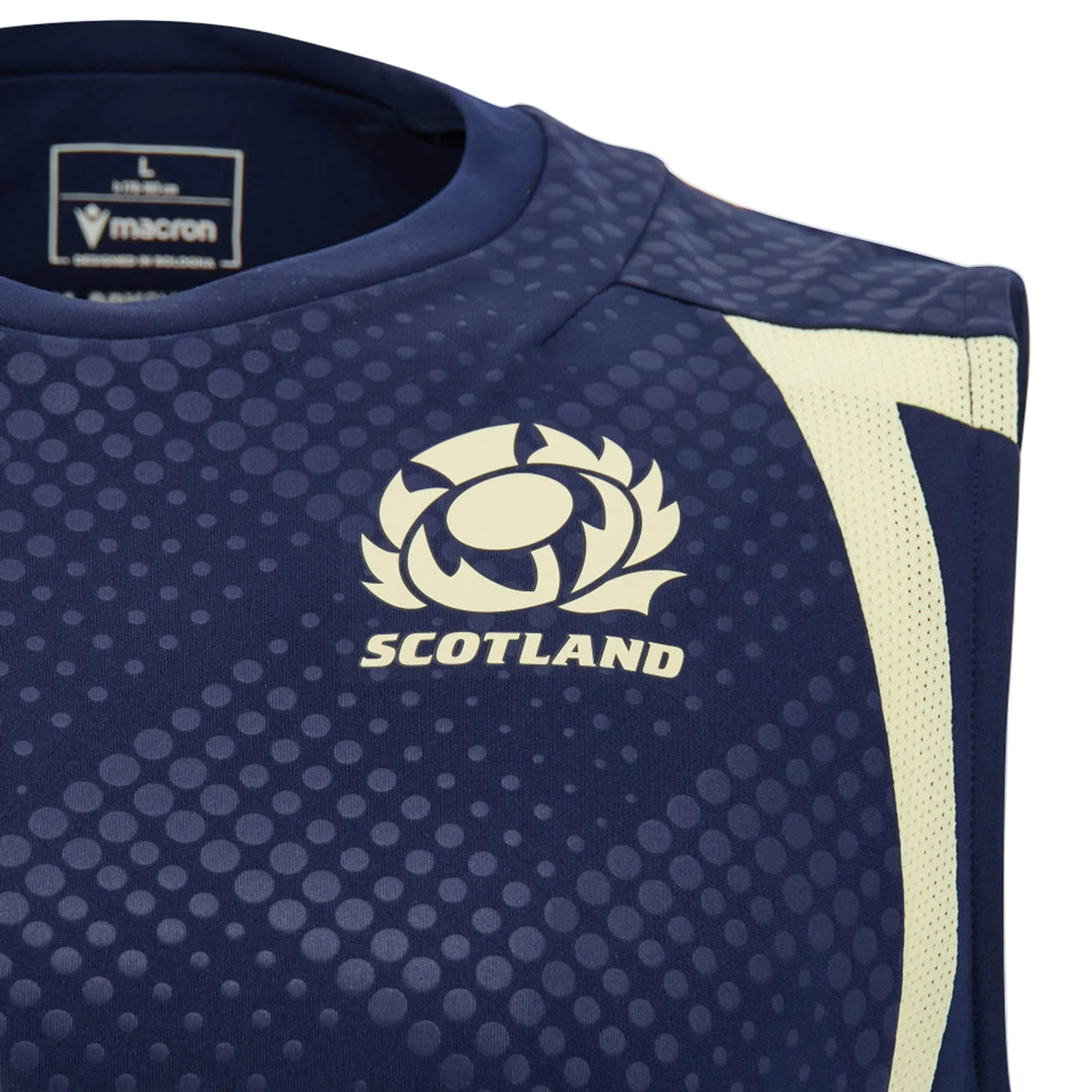 Close-up of the Scotland SRU 26/27 Player Training Singlet by Macron in blue, showcasing the white Scotland rugby logo, Macron branding, and a light yellow diagonal stripe on the shoulder. This sleeveless player training tank top is part of the official Macron 2026/27 collection.