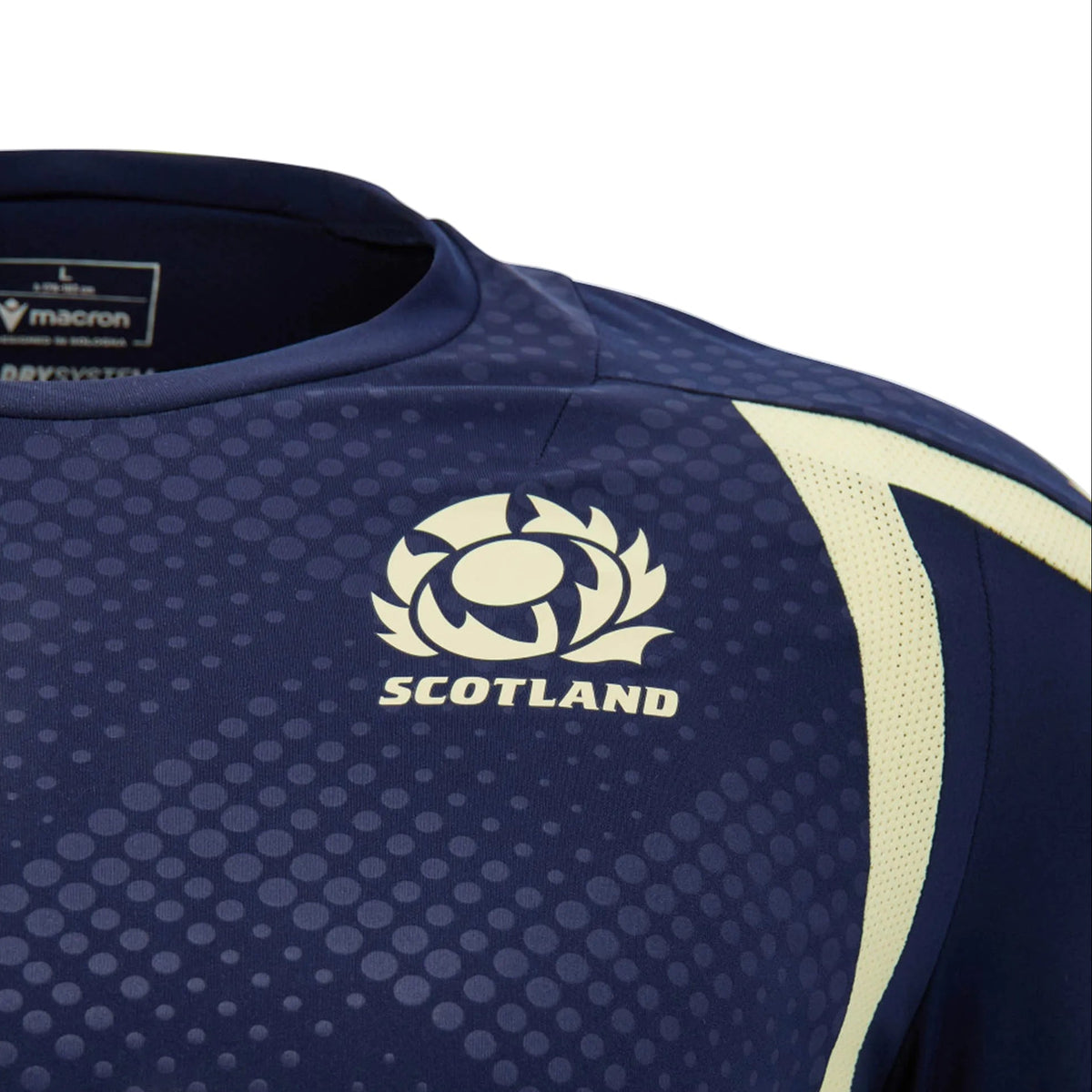 Close-up of the Scotland SRU 26/27 Player Training Shirt by Macron—an official navy blue Scotland Rugby training jersey—showing the Scottish Rugby logo and Macron brand tag on the inside collar.
