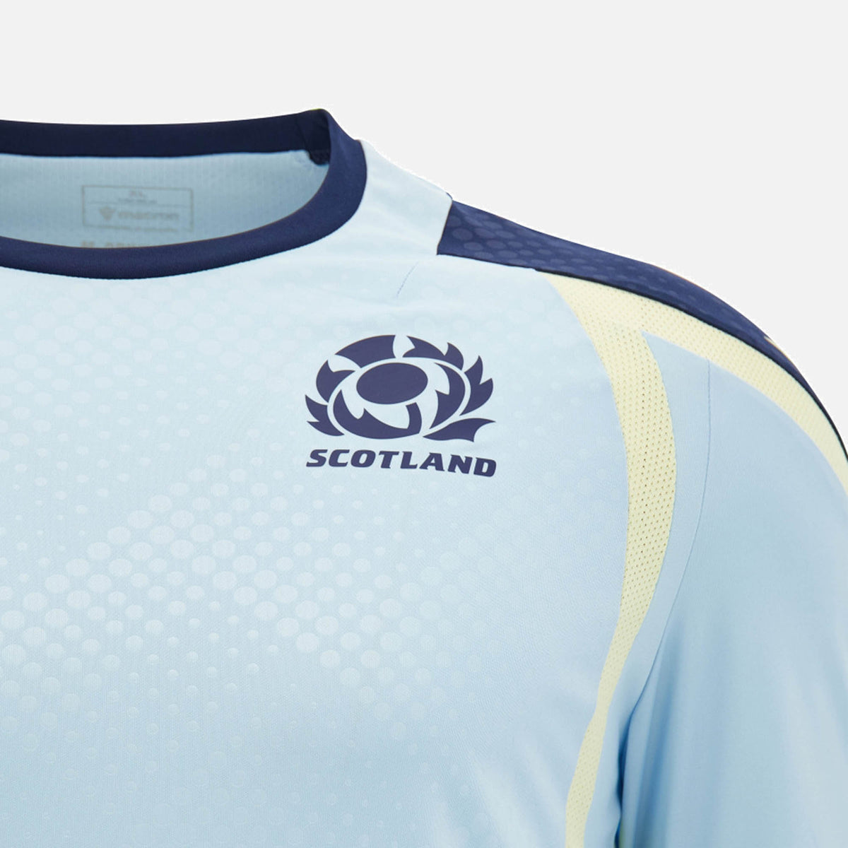 Close-up of the Scotland SRU 26/27 Player Training Shirt by Macron in light blue, showcasing the Scotland rugby logo and dark blue trim on the collar and shoulder.