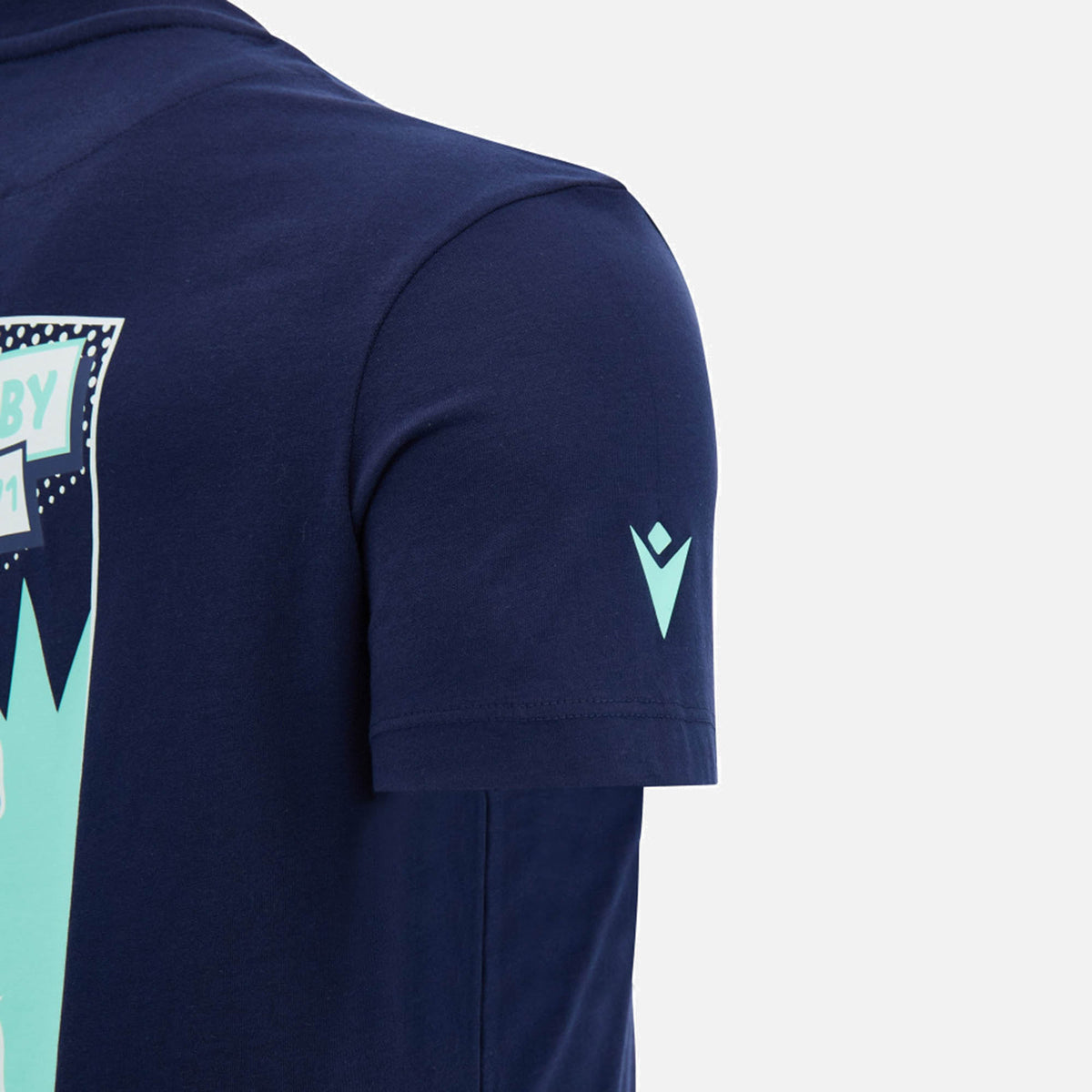 Close-up of the sleeve of the Scotland SRU 26/27 Leisure Cotton T-Shirt by Macron in navy blue, featuring a small white Macron logo near the cuff and part of a light blue graphic on the back.