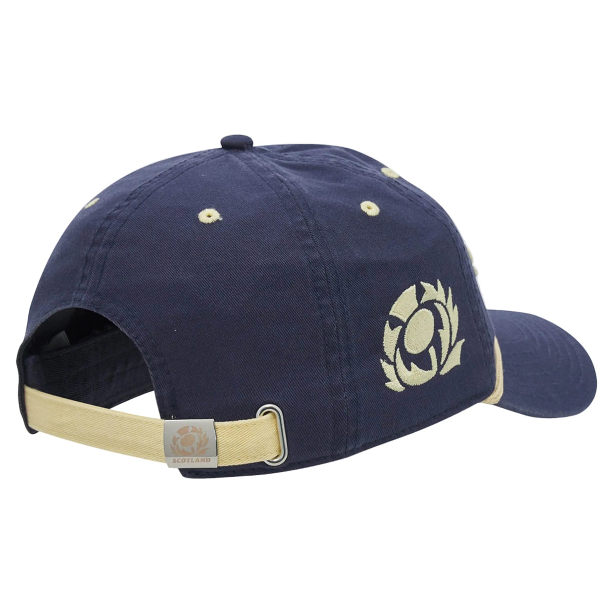The Scotland SRU 26/27 Dad Cap by Macron is a navy blue baseball cap with beige accents, featuring the official Scotland Rugby logo and an SRU 26/27 emblem on the side, finished with an adjustable strap at the back.