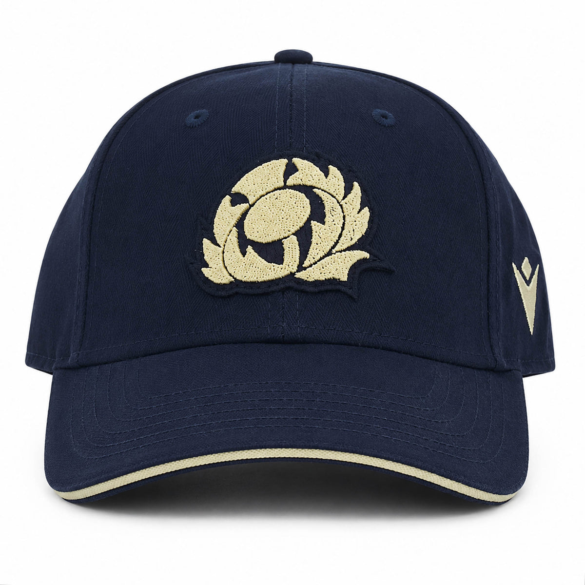 The Scotland SRU 26/27 Thistle Baseball Cap by Macron features a navy blue design with a cream embroidered thistle logo on the front and a cream stripe on the brim.