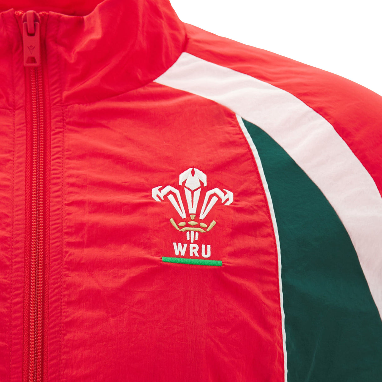 The Wales WRU 26/27 Heritage Retro Jacket by Macron features a distinctive red design with the official WRU logo, accented by white and green stripes on the shoulder and chest. Blending classic heritage rugby style with modern comfort, this jacket from Macron is perfect for any Wales supporter.