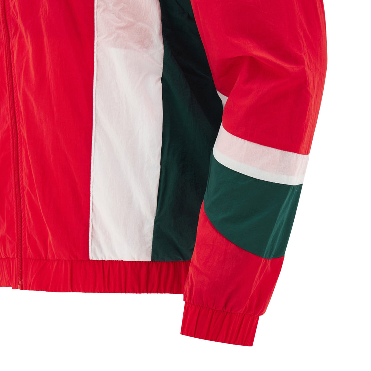 Close-up of the Wales WRU 26/27 Heritage Retro Jacket by Macron sleeve, featuring red, white, and green color-blocking with an elastic cuff and part of the matching torso section visible.