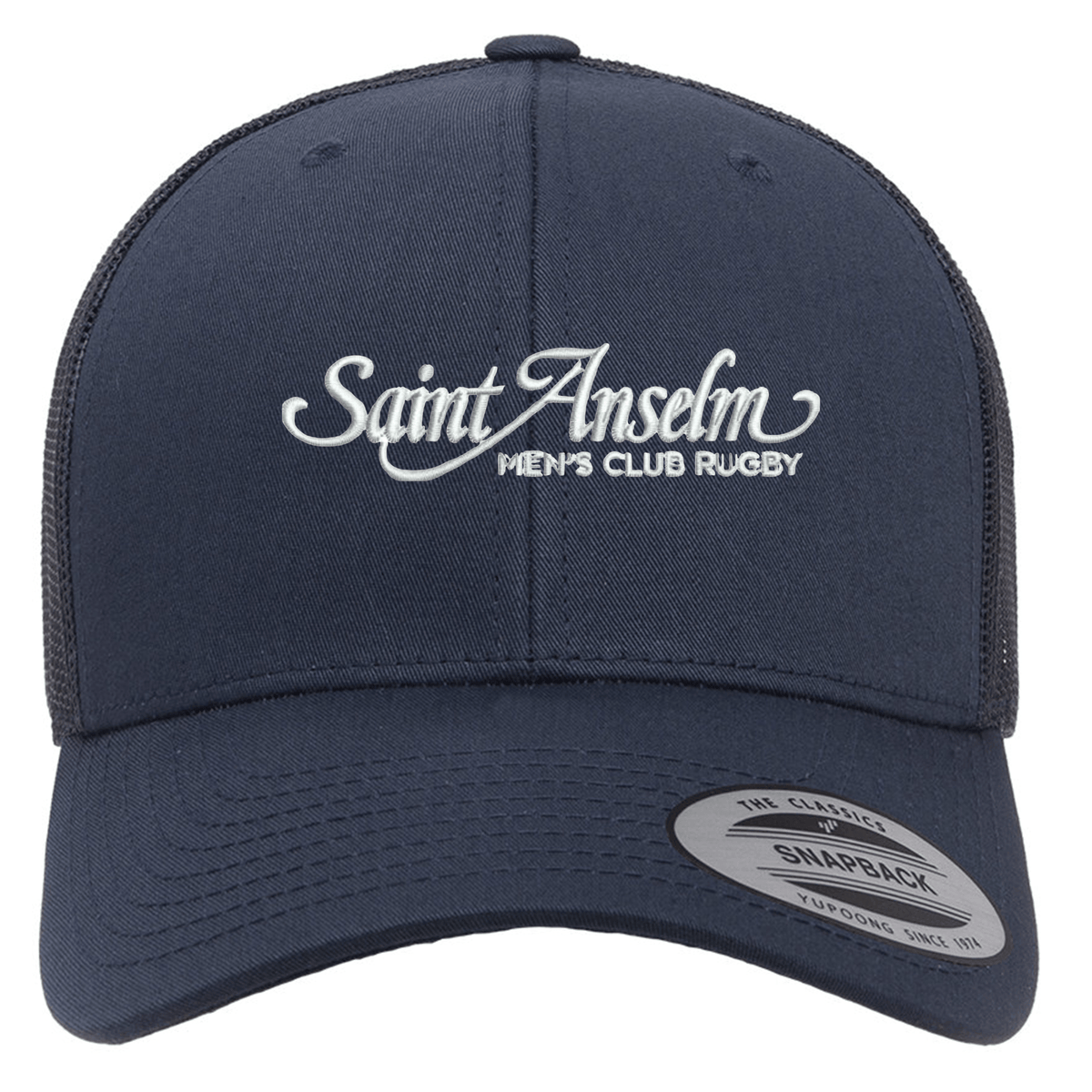 The EMB S&S Activewear Saint Anselm College Club Rugby Retro Trucker Cap features navy blue mesh, "Saint Anselm Men's Club Rugby" embroidered in white on the front, and a snapback closure for an adjustable fit.