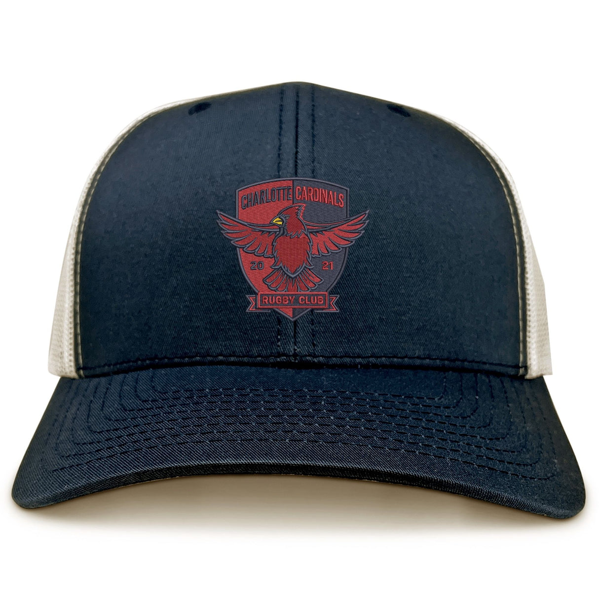 The Charlotte Cardinals Retro Trucker Cap by EMB S&S Activewear features navy blue and white panels, a red eagle logo, "Charlotte Cardinals Rugby Club 2021" on the front, retro trucker design, and adjustable snapback closure.