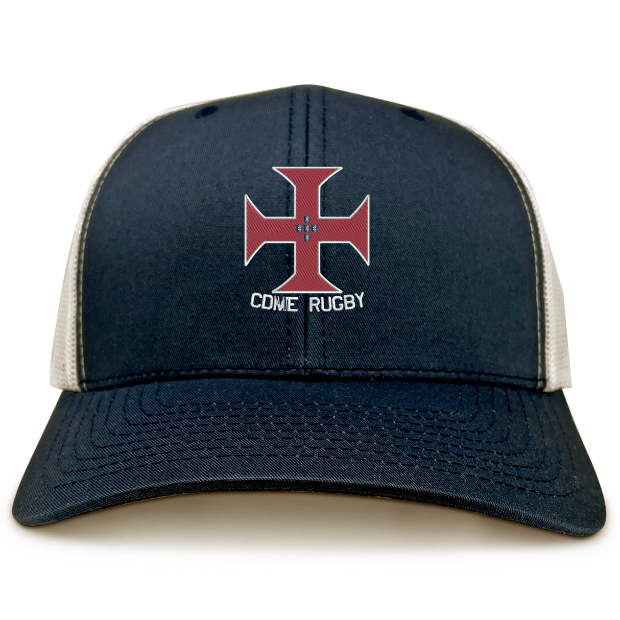 The SF CDME Rugby Retro Trucker Cap by EMB S&S Activewear features a navy and white design with a bold embroidered red cross emblem and “CDME RUGBY” text on the front panel, and includes an adjustable snapback closure for a comfortable fit.