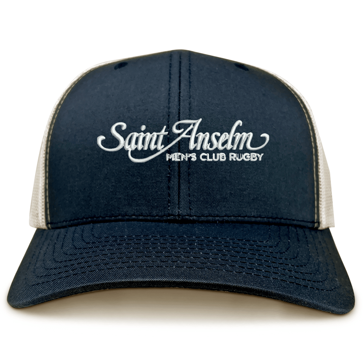 The Saint Anselm College Club Rugby Retro Trucker Cap by EMB S&S Activewear features a navy and white design, "Saint Anselm Men's Club Rugby" embroidery on the front, and a classic snapback closure for an adjustable fit.