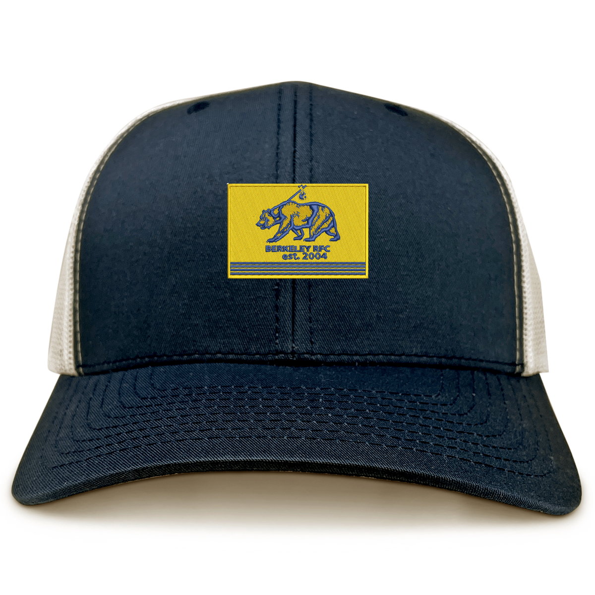 Berkeley RFC Retro Trucker Cap in navy blue with a snapback closure and a rectangular patch featuring a blue grizzly bear and “BERKELEY RFC est. 2004” on a yellow background.