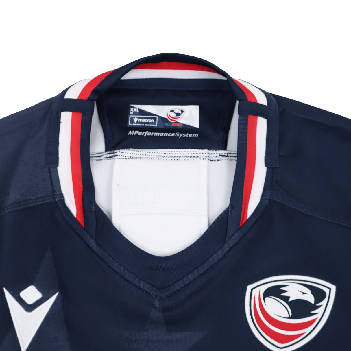 The Women's USA Rugby 24/25 Home Body Fit Jersey by Macron is navy blue with red, white, and blue trim. It features an eagle head badge and the Macron logo on the chest.