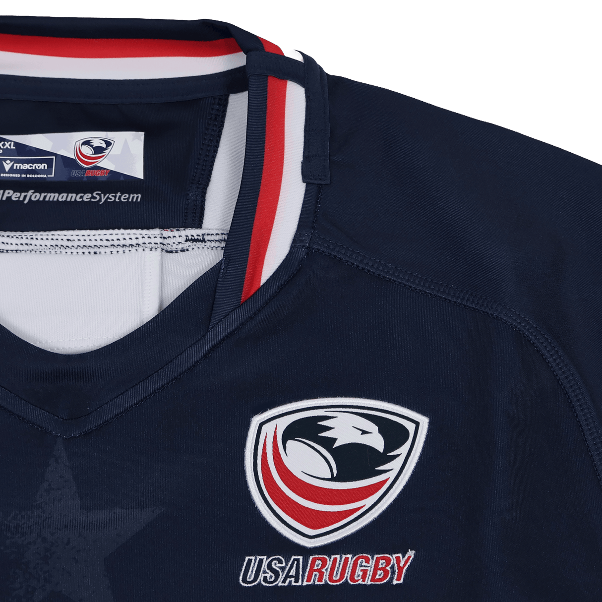 Macron Women's USA Rugby 24/25 Home Bodyfit Shirt features the team logo, "USA RUGBY" text, red, white, and blue collar accents in a flattering navy Bodyfit design.