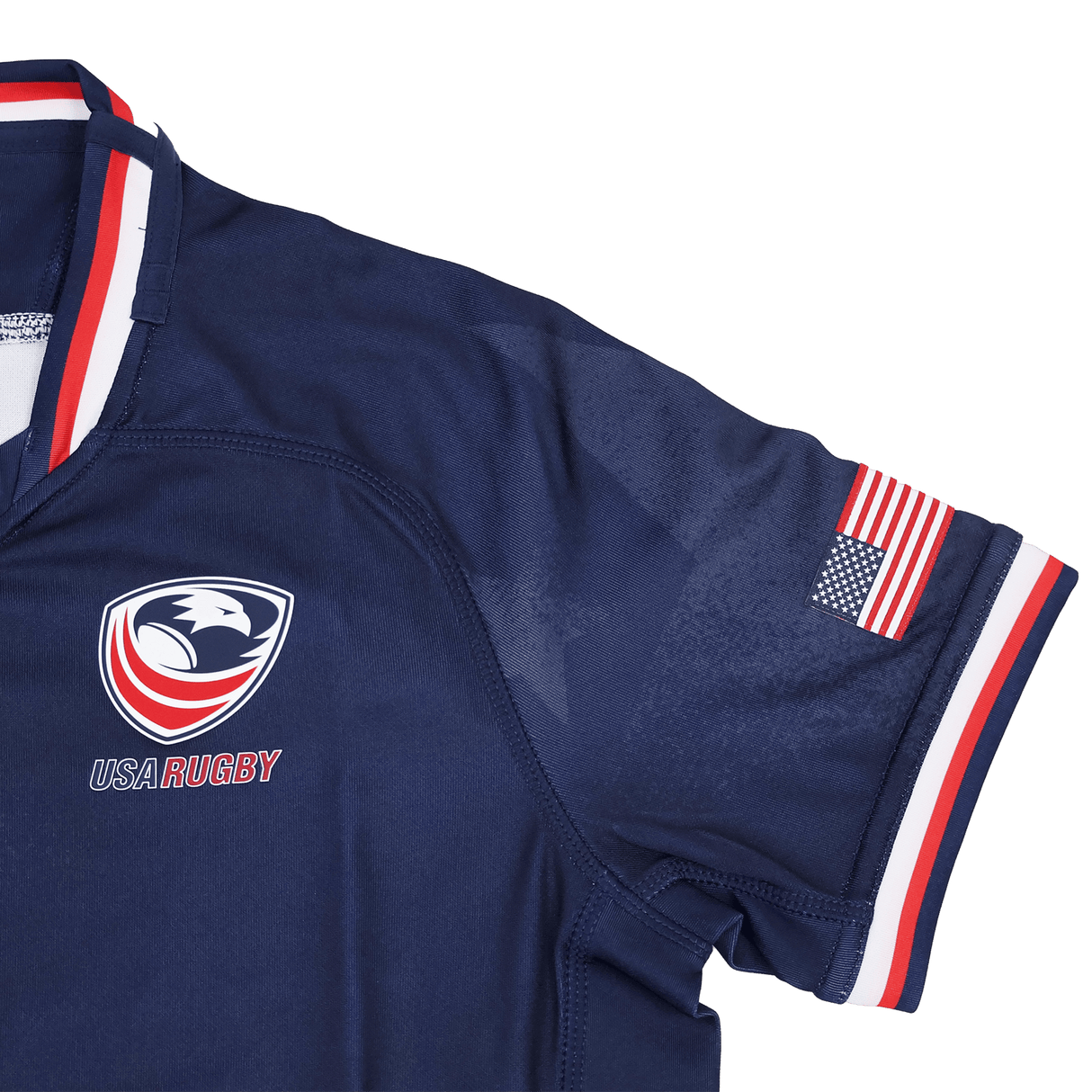 The Youth USA Rugby 24/25 Home Jersey by Macron features the team logo on the chest, an American flag patch on the sleeve, and red, white, and blue trim. A great choice for young fans to show USA Rugby pride.