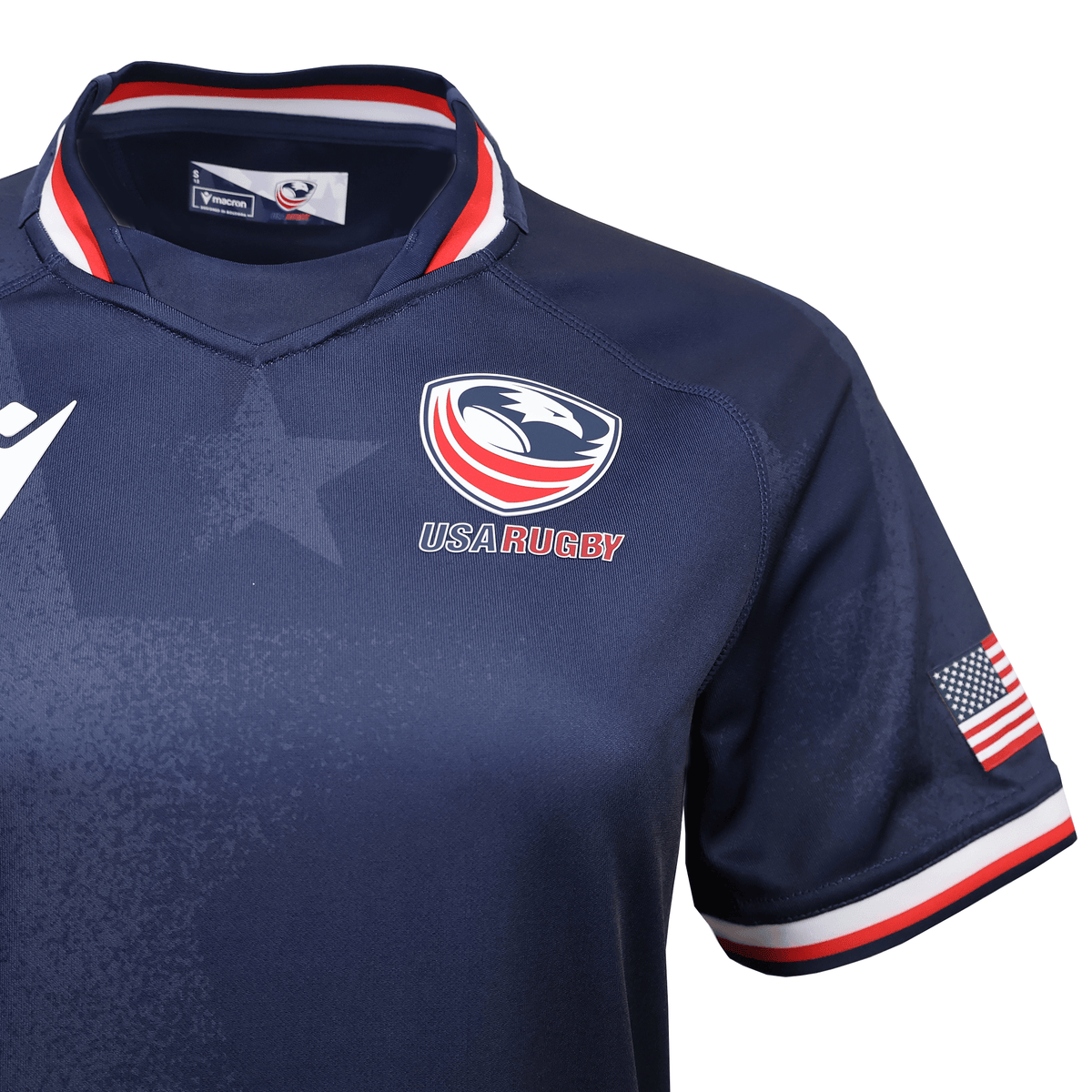Show your pride in the Women's USA Rugby 25/26 Replica Home Jersey by Macron, featuring a navy blue design, team logo on the chest, American flag patch on the sleeve, and red, white & blue trim on collar and cuffs.