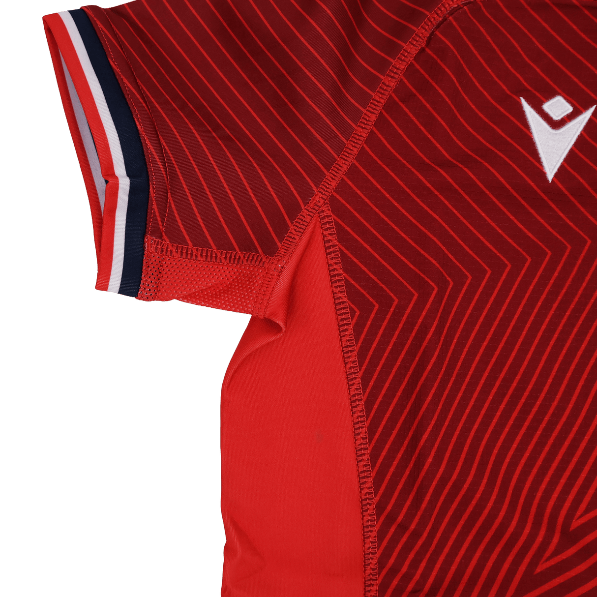 Close-up of the Youth USA Rugby Training Jersey by Macron shows thin diagonal stripes, a white Macron logo, and red, white, and blue trim on the sleeve edge.