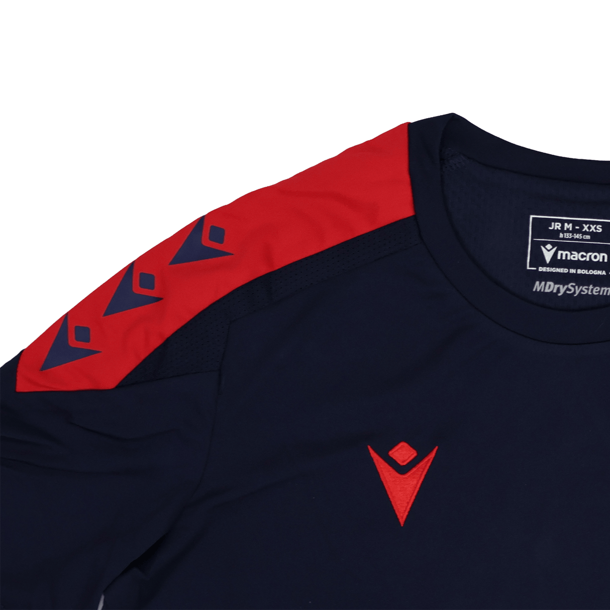 The Youth USA Rugby 24/25 Training Poly Shirt by Macron features a navy design with a red shoulder panel, geometric logos on the chest and sleeve, plus visible interior sizing and Macron USA Rugby branding.