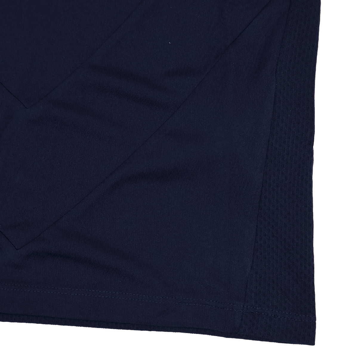 Close-up of navy blue fabric, showcasing textures and stitching details along the hem and side, from the Youth USA Rugby 24/25 Training Poly Shirt by Macron.