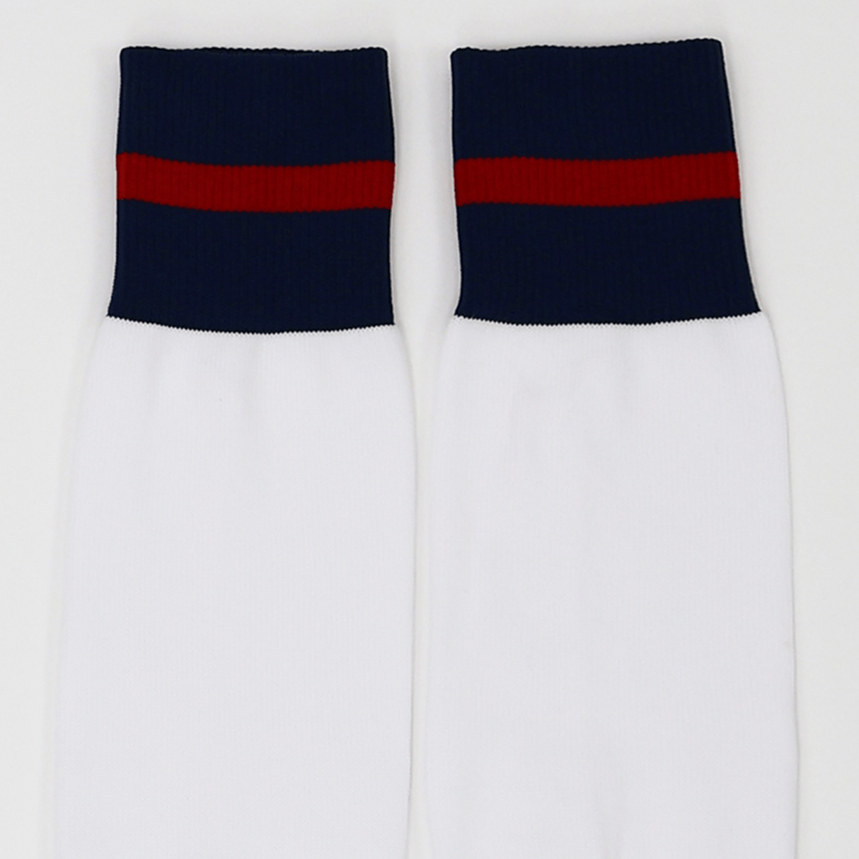 The USA Rugby M25/26 Home Socks by Macron are white performance socks featuring navy blue cuffs and a red horizontal stripe near the top, designed for comfort and durability.