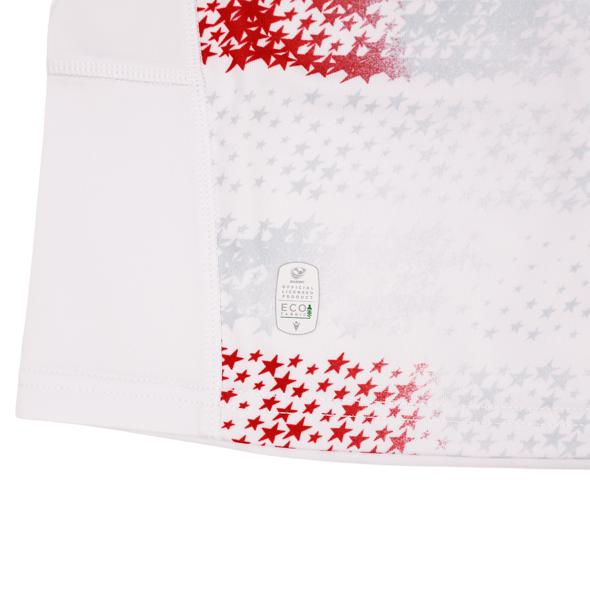 The Youth USA Rugby 25/26 Home Replica Jersey by Macron features white fabric with red and gray stars, visible stitching, and an "Eco" label near the hem, combining sporty style with everyday comfort.
