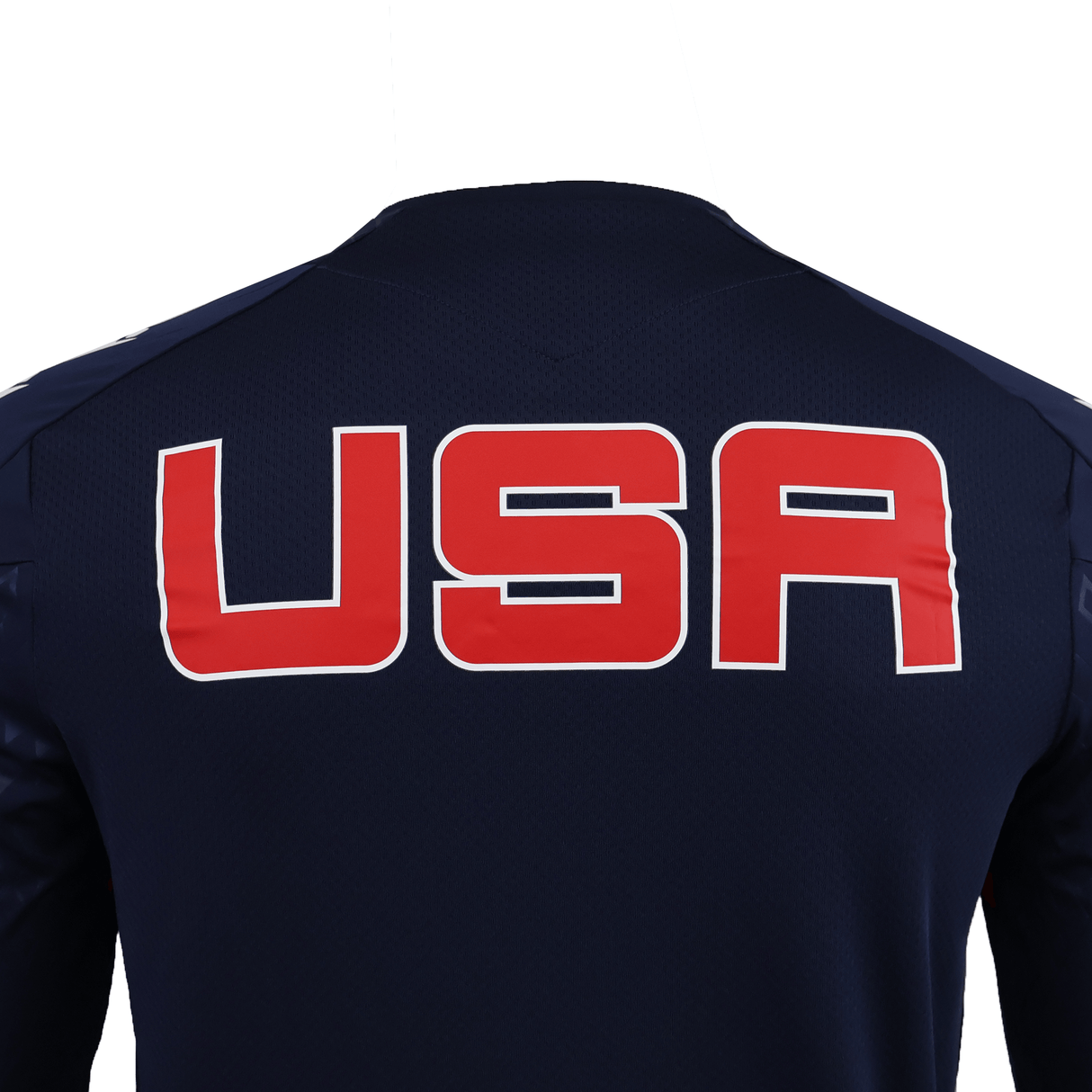 Person wearing a dark blue USA Rugby 25/26 LS Training Poly Shirt by Macron, featuring bold red and white "USA" lettering on the back, shown from behind against a plain white background.