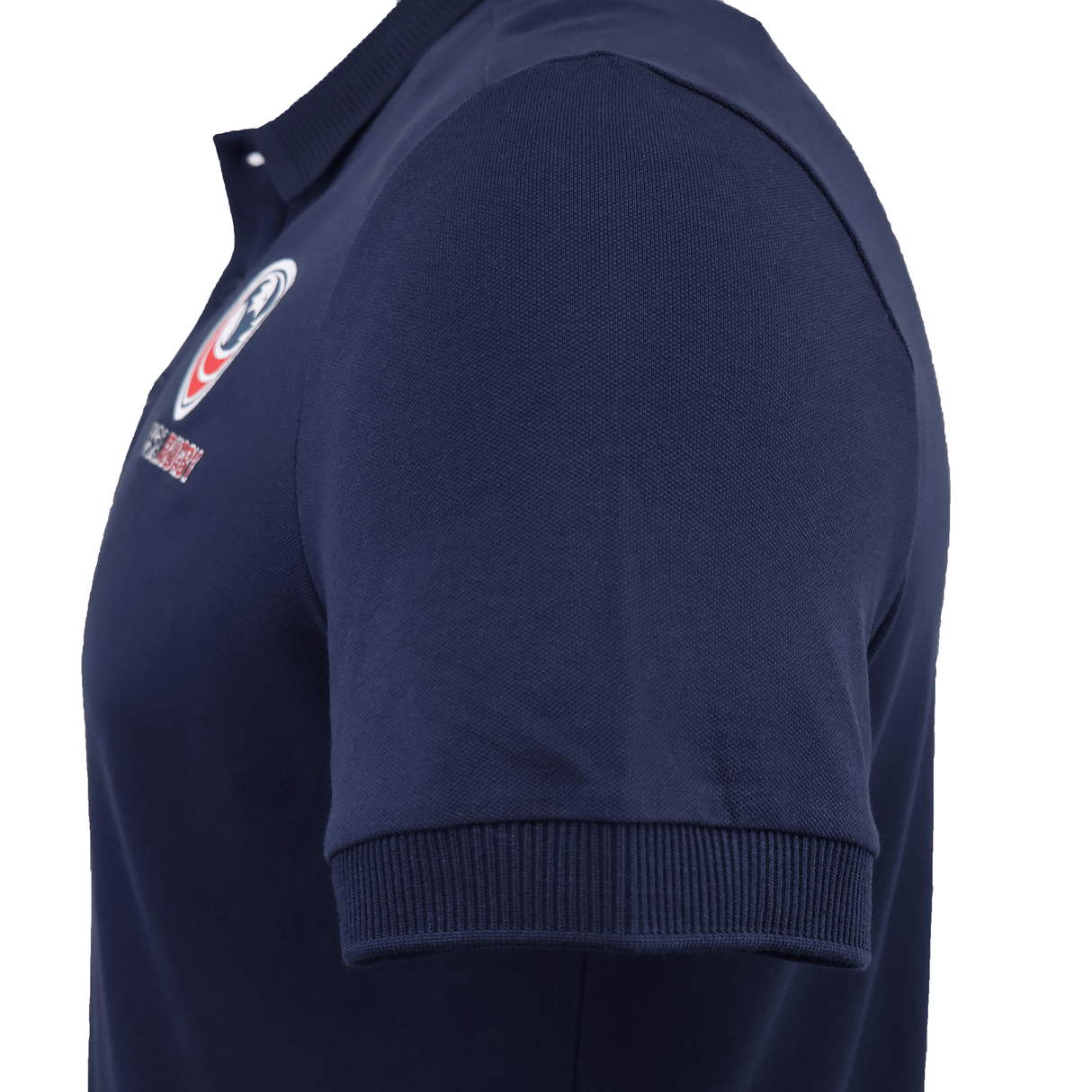 Side view of the USA Rugby 25/26 Athleisure Cotton Polo by Macron in dark blue, featuring a ribbed collar, sleeve cuffs, and a small embroidered chest logo for an easy athleisure style.