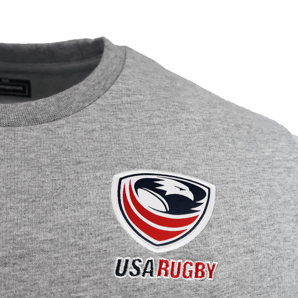Close-up of the USA Rugby 25/26 Player Travel Sweatshirt by Macron in gray, featuring the official logo and "USA Rugby" embroidery. Perfect for fans and athletes as a stylish player travel sweatshirt.