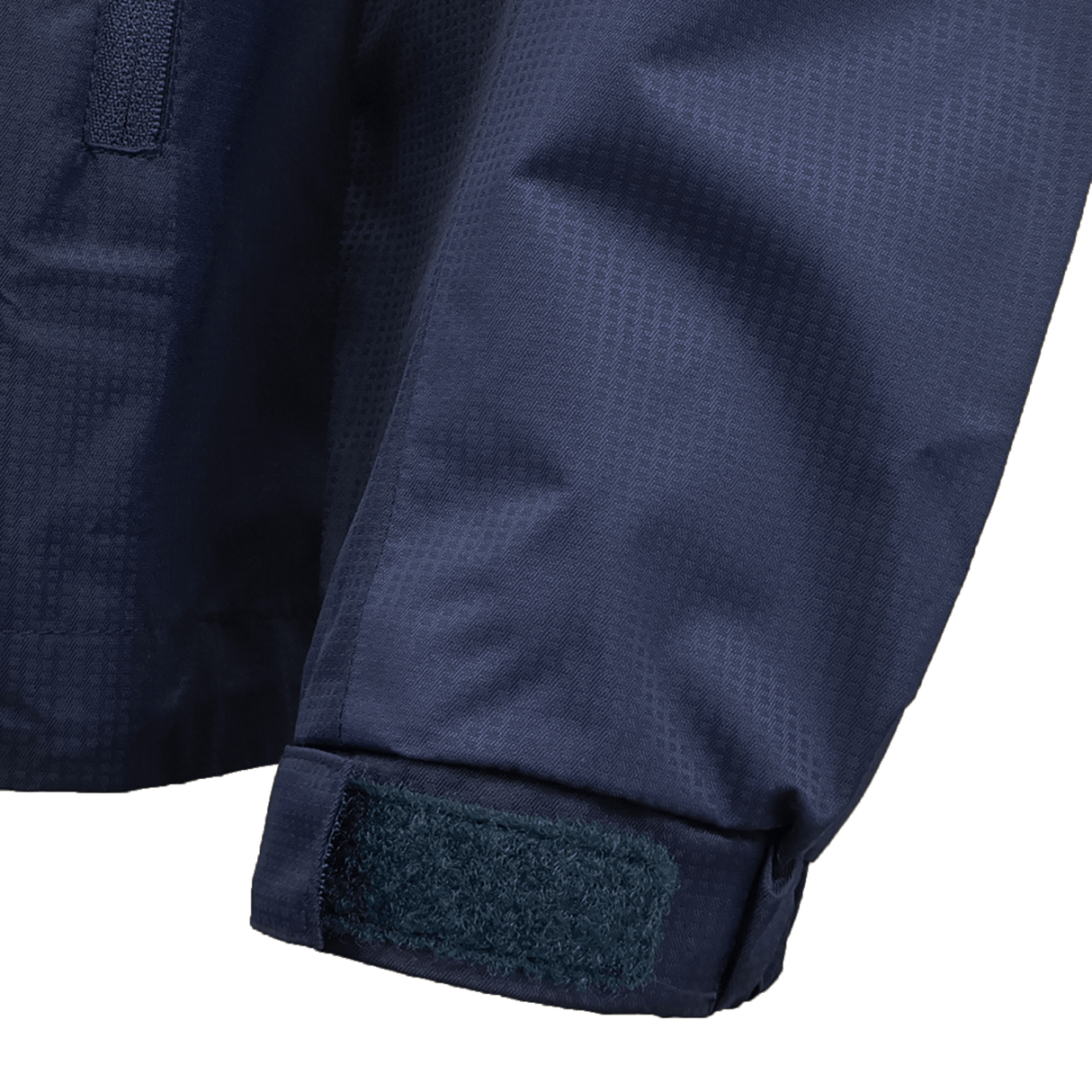 Close-up of the USA Rugby 25/26 Rain Jacket by Macron shows a navy blue sleeve with a hook-and-loop cuff strap and subtle textured fabric, designed to keep you dry in wet weather.