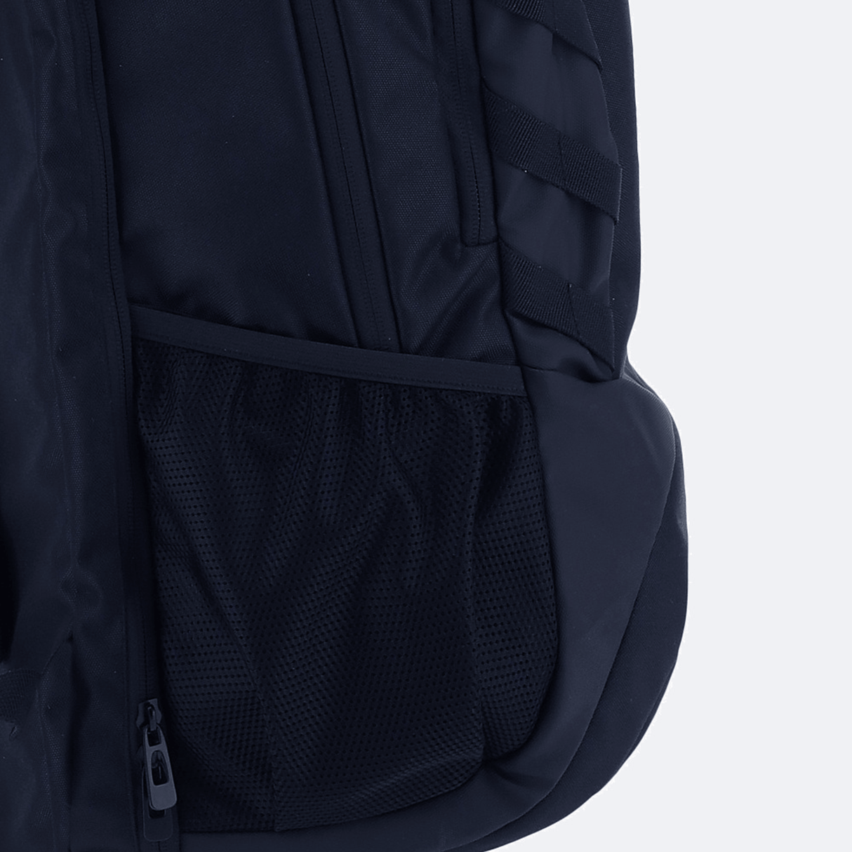 Close-up of the USA Rugby 25/26 Athleisure Backpack by Macron, highlighting its mesh side pocket, zippered compartment, and padded strap against a plain background.