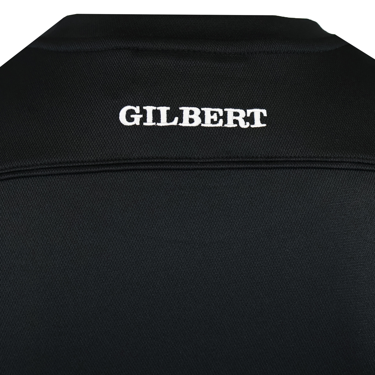 The Gilbert Photon Training Tee features black moisture-wicking fabric with "GILBERT" embroidered in white at the top center—ideal for training sessions.