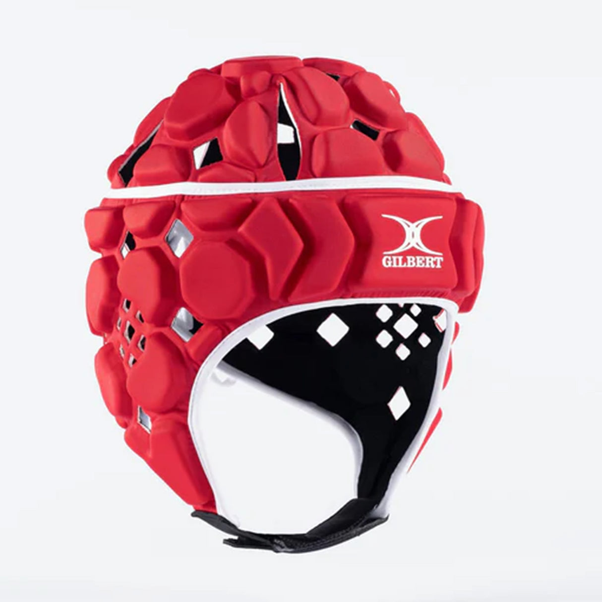 The Gilbert Octane Headguard is a red padded rugby headguard with hexagonal EVA padding for superior protection. It features a black chin strap, white trim, and the "Gilbert" brand logo displayed prominently on the forehead. This protective headgear is shown against a plain white background.