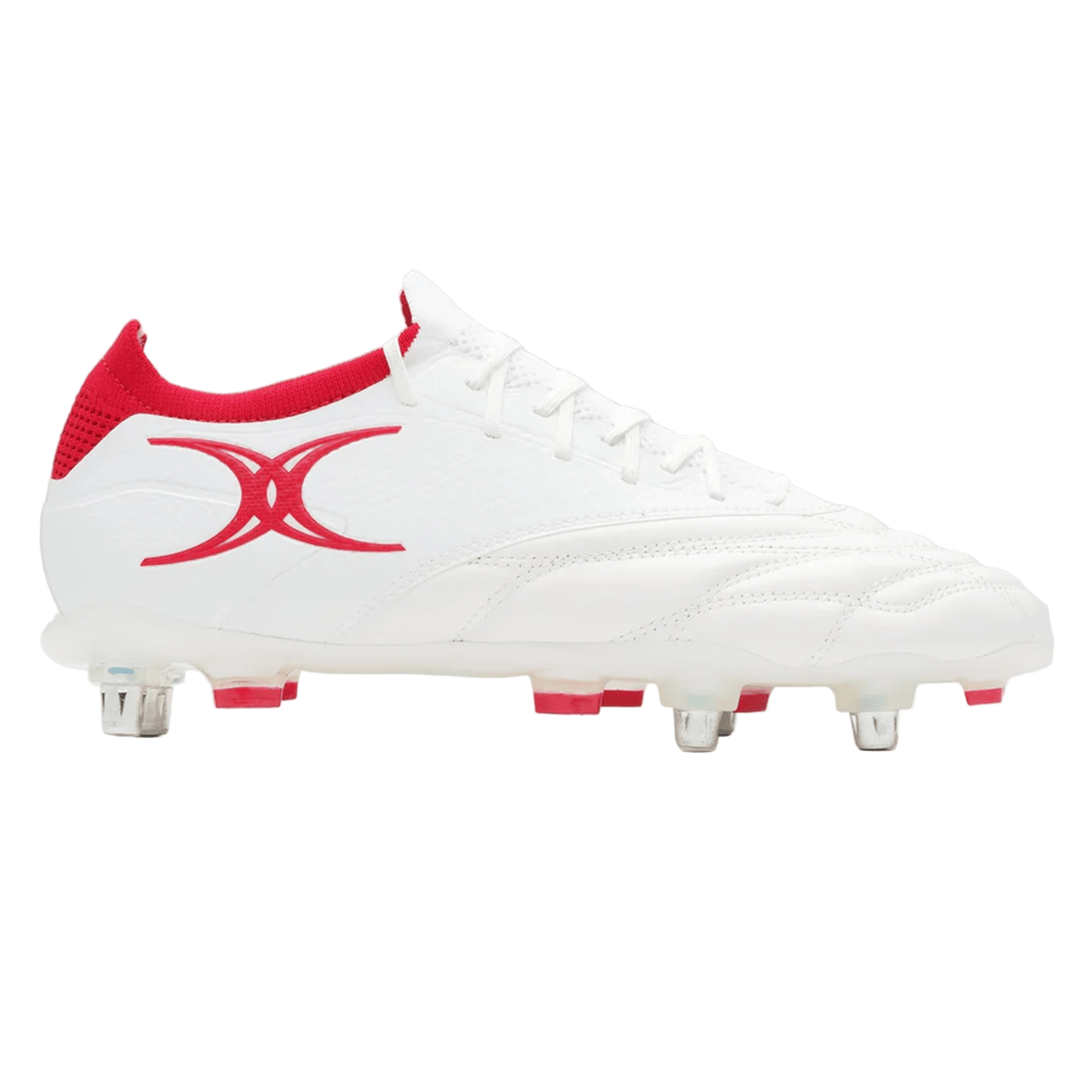 The Gilbert Icon Players 6S - White is a white soccer cleat by Gilbert, designed for elite players, featuring red accents, a red side logo, and metal studs on the sole for superior grip on soft ground.