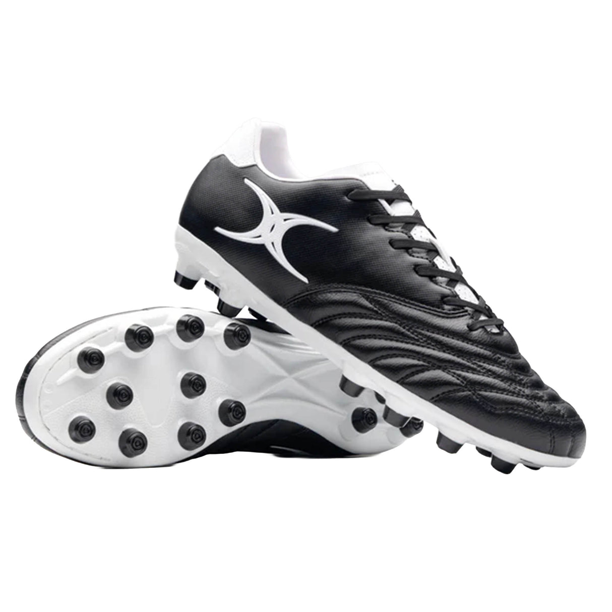A pair of Sidestep Icon MSX rugby boots by Gilbert in black and white, featuring a synthetic leather upper and a prominent white Gilbert logo—one boot is displayed upright while the other shows the studded sole, designed specifically for firm ground rugby play.