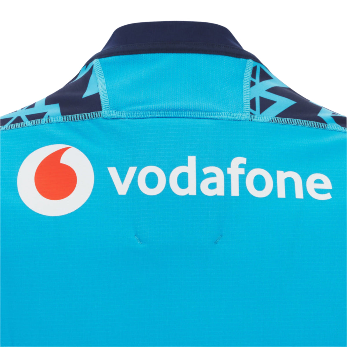 Close-up of the back of the Scotland 25/26 Sky Training Jersey by Macron, a blue rugby top featuring the Vodafone logo and text in white.