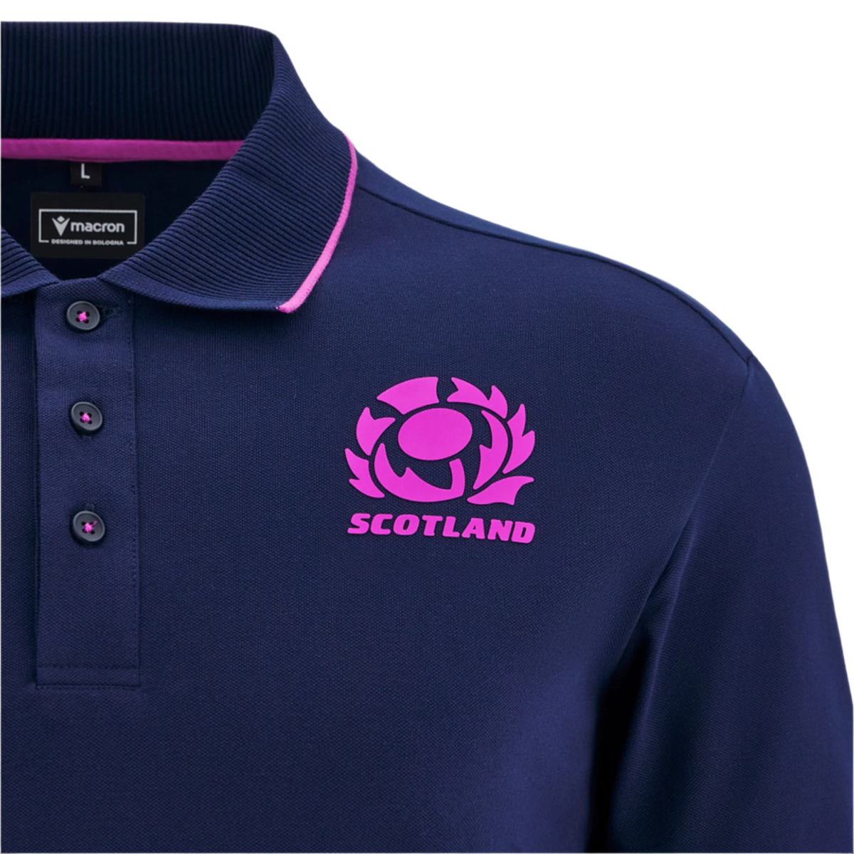 Scotland 25/26 Player Travel Cotton Polo by Macron in navy blue with pink trim, featuring the Scottish Rugby crest and "SCOTLAND" on the chest; Macron brand label inside the collar.