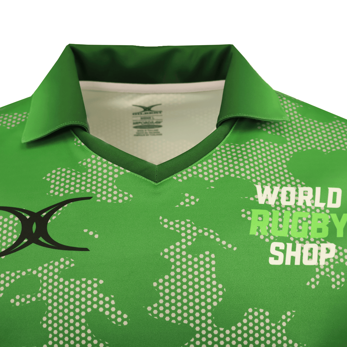 A close-up of the Gilbert Sublimated Pro Collared Jersey - Mens by Teamatical, featuring a green pixelated pattern, black logo on the left chest, and "WORLD RUGBY SHOP" text on the right.